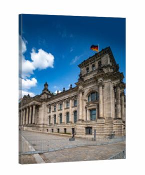 Front view of Reichstag building. Historic Reichstag architecture in Berlin. Reichstag Political symbol of Germany. German flag over Reichstag.