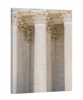Monumental columns define classical architecture. Tall marble pillars shape historic architecture. White stone columns express civic architecture. Supreme Court columns suggest justice and authority.