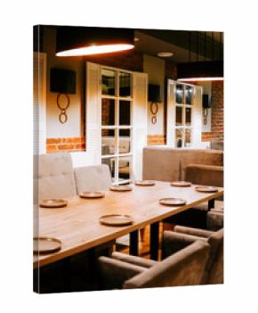 Dining area with wooden table and soft seating for guests in a restaurant setting