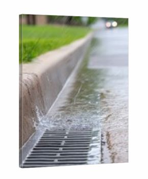 Stormwater flows down urban street as rainwater collects on metal grates during heavy rainfall, showcasing the importance of surface runoff in the city