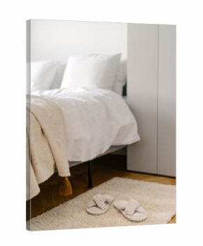 Modern hotel bedroom with comfortable bed and cozy textile decor