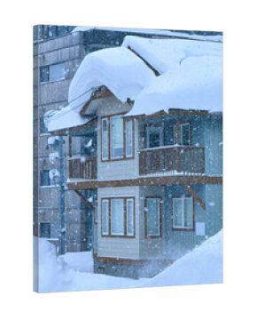 Charming wooden house stands amidst a heavy snowstorm in a ski town. The roof is laden with thick layers of snow, and large icicles hang from the edges. Magical picture of a pure winter wonderland.