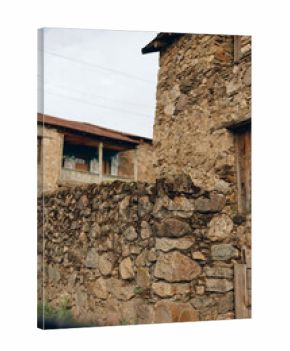 Stone wall village building rustic masonry texture doorway facade in rural old town with weathered stones