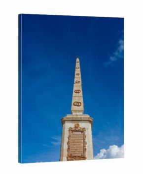 Exploring the historic Torrijos Monument in Malaga's Plaza de la Merced
