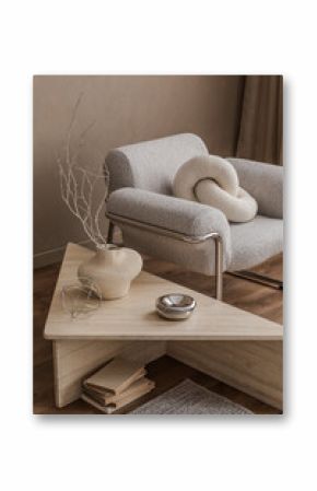 Stylish composition of living room featuring  armchair, a minimalist vase and dried flowers, emphasizing subtle textures and natural materials.