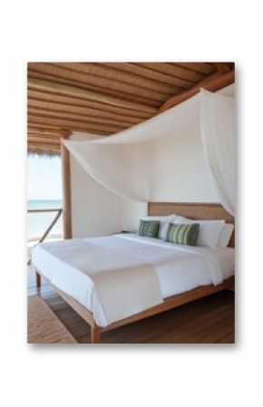 A bed with a white canopy and pillows. The bed is in a room with a wooden floor and a view of the ocean
