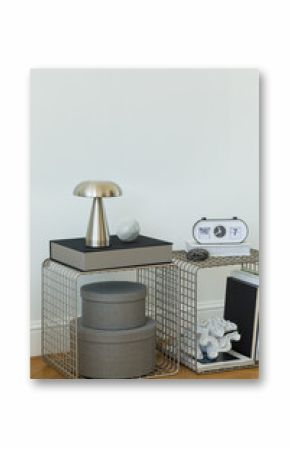 Elegant bedroom corner with chrome lamp, abstract art, and monochrome decor accents.