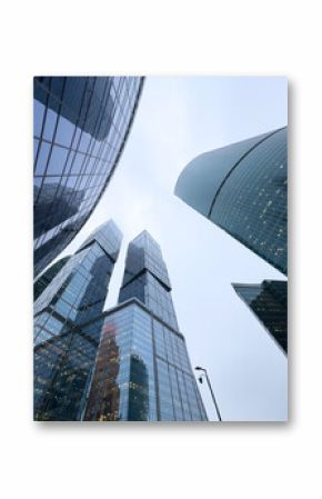 A city skyline with tall buildings and a cloudy sky