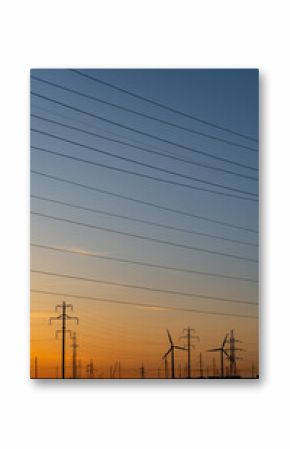Wind power plants and power transmission lines against the sunset sky