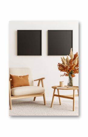 A cozy armchair sits beneath two blank square frames with autumn floral decor on a small wooden table.