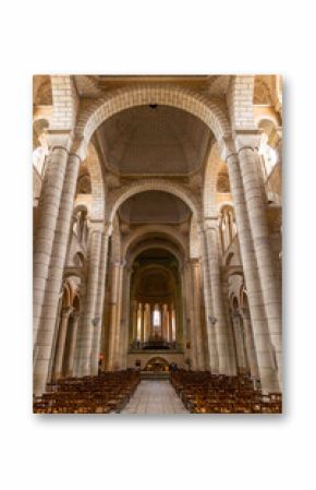 Interior of Eglise Saint Hilaire le Grand showing romanesque architecture and wooden chairs in Poitiers, France