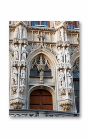 Closeup of lace-like sculptural details and statues on facade of gothic Leuven Town Hall building. Famous Belgian landmark