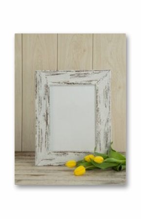 Photo frame and flowers on table