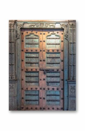 A rustic, vintage double wooden door. Carved detail of a vintage old wooden door with metal latch