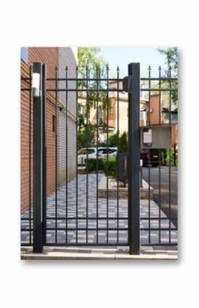 Closed courtyard of a residential building with an electronic code lock on the fence.