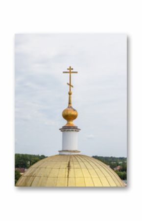 A golden church dome crowned with a cross under cloudy sky