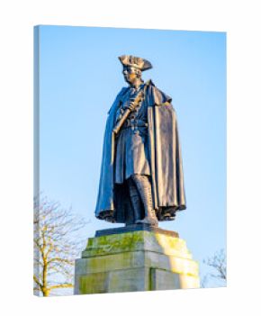 The statue of General James Wolfe stands tall in Greenwich, London. This landmark honors the general's legacy and is set against a clear blue sky, showcasing the city's rich history.
