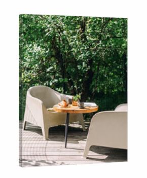 Brunch on a sunny terrace with fresh coffee and a croissant