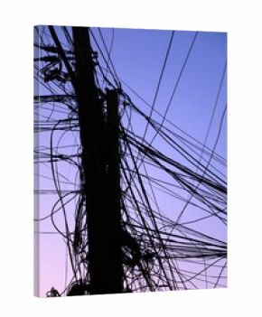 Tangled messy wires - city cables against the sky in Tirana, Albania. Utility cables, internet cables and telephone wires.
