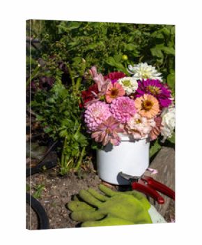 Garden bouquet in bucket with green gloves and shears