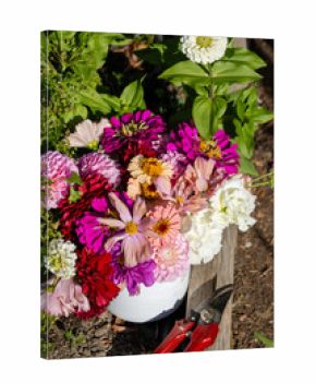 Overhead view of bouquet and shears in garden soil