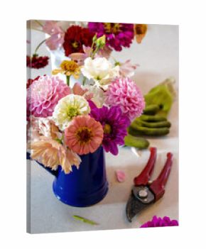 Garden flower arrangement with clippers and green gloves