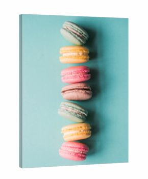 Top view close up of colorful macarons on blue background.