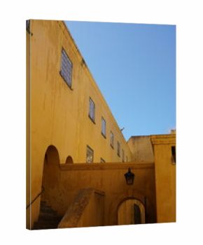 Yellow walls of a building against blue sky