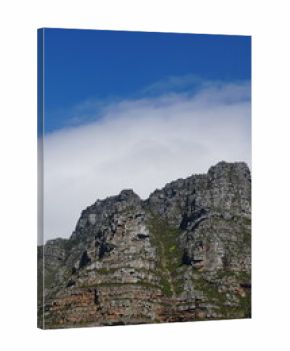 Rocky mountain against cloudy sky backdrop