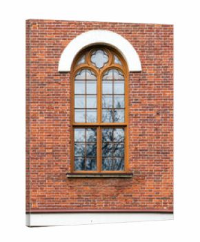 Red brick exterior featuring a wooden-framed window with Gothic details