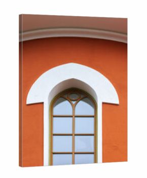 Bright orange building facade features a white rounded arch and a tall arched window