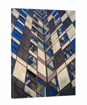 abstract view of a modern skyscraper facade featuring a repeating checkerboard pattern of dark panels and reflective windows in shades of blue and white.