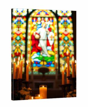 All Saints’ Day memorial scene inside a church, glowing candles arranged in rows, warm candlelight reflections, a large vertical stained glass window depicting saints
