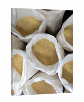 Overhead looking down at open sacks of crushed corn for distilling