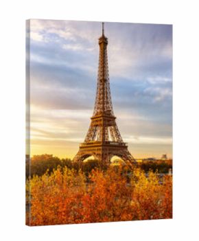 Beautiful autumn sunrise view of the Eiffel Tower in Paris, France, with golden sunlight and colorful leaves