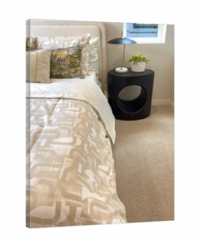 Bedroom with patterned bedding and nightstand