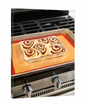 Freshly Baked Cinnamon Rolls Cooling on Stove Top