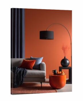 Modern living room with burnt orange wall, grey sofa and blue accents