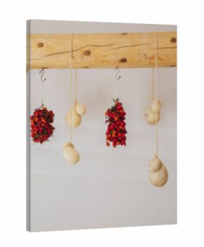 tomotoes and cheese hanging from wood in Italian prep kitchen