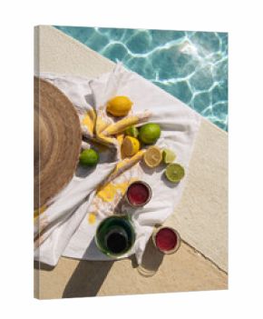 citrus and drinks next to pool on sunny day