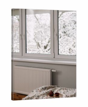Window view of snowy trees from a cozy room during winter season