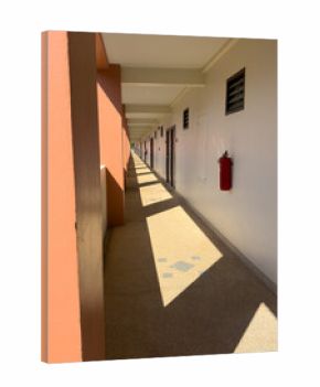A hallway with a red fire extinguisher on the wall