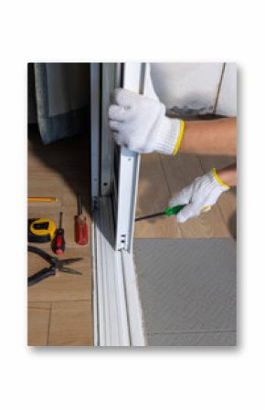Worker fixing derailed roller of sliding door. Replace Sliding Glass Door Rollers concept
