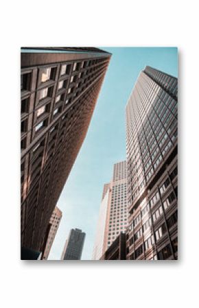 A city skyline with tall buildings and a clear blue sky