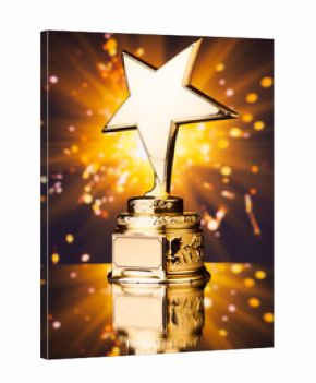 gold star trophy against shiny sparks background