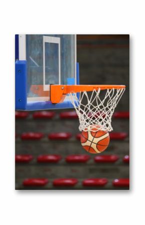 basketball in the basket during the game in the sports hall