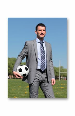 businessman with ball in a park in summer