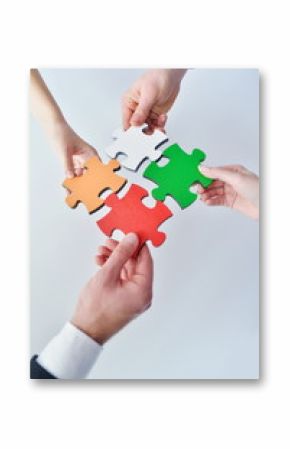 Group of business people assembling jigsaw puzzle
