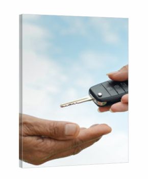 hand holding a key and blue sky