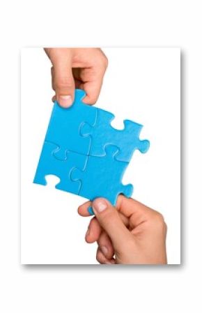 Closeup on Hands Combining Puzzle Pieces Together